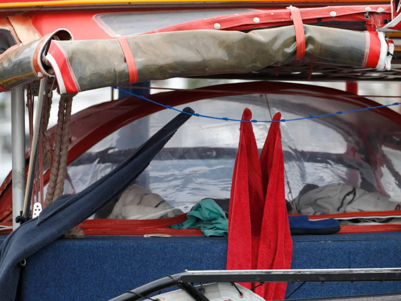 In this image there is a vehicle having clothes. Left side there are ropes and metal rods. Bottom...