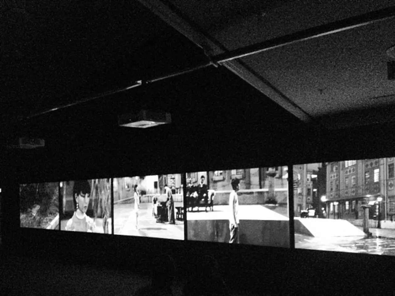 In this image I can see number of screens and on it I can see number of people and few buildings. I...