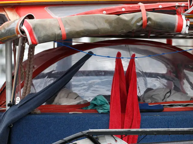 In this image there is a vehicle having clothes. Left side there are ropes and metal rods. Bottom...