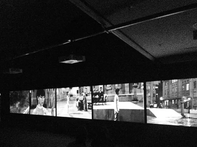 In this image I can see number of screens and on it I can see number of people and few buildings. I...