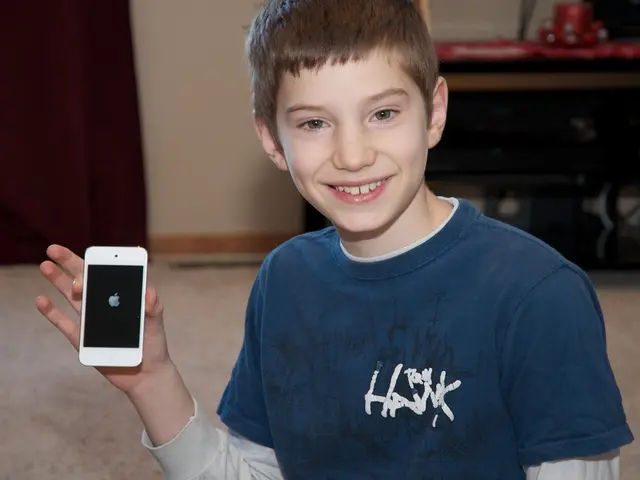 As we can see in the image there is a wall and a boy holding mobile phone.