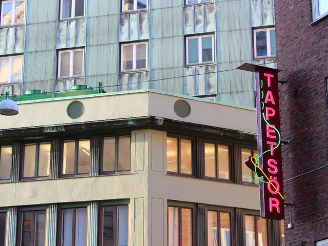 In this image there are some buildings, windows, wire. On the left side there is some object, and...