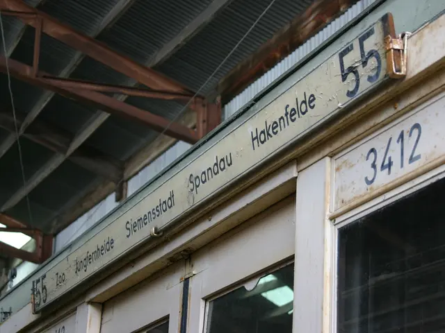 In this picture there is a small shop with naming board. Above there is a metal frame shed.