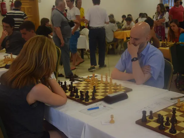 In this picture there are group of people who are sitting and playing chess. There is a pen, paper...