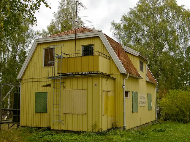 In this image there is a house in middle of this image and there are some trees in the background...