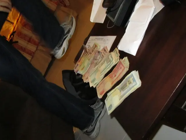 In this picture there is a man walking and there is a table beside him with some money and...