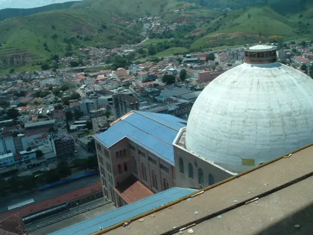 On the right side, there are coins on a wall. On the left side, there are vehicles on the roads,...