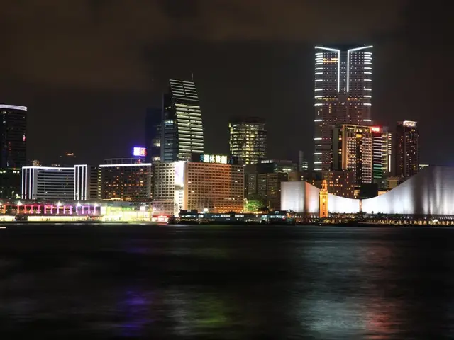 In the image there are skyscrapers in the back with many lights all over it, in the front it seems...